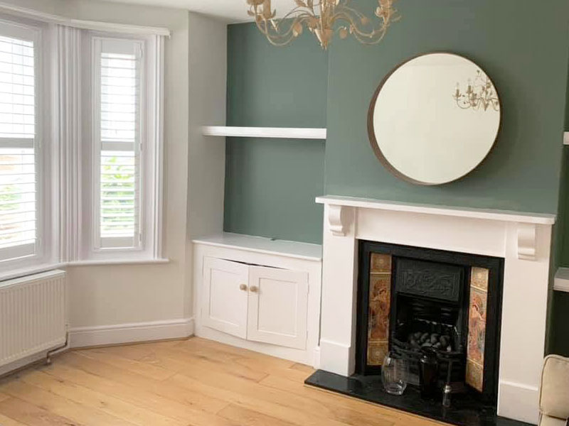 interior image of a newly decorated lounge with newly painted woodwork and walls with a wooden flooring by Hi-Lite Decorating and Property Maintenance